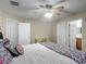Bedroom has a desk with chair, and two doorways each with a full length door at 400 Landress Ln, Deland, FL 32724