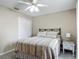Well-lit bedroom features a double bed with striped bedding and a double door closet at 400 Landress Ln, Deland, FL 32724