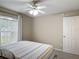 Neutral toned bedroom featuring a ceiling fan, window with blinds and comfy looking bed at 400 Landress Ln, Deland, FL 32724