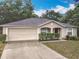 Attractive single-story home with a well-maintained lawn, two-car garage, and a classic facade at 400 Landress Ln, Deland, FL 32724