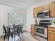 Bright kitchen features stainless steel appliances, oak cabinets, and a breakfast nook at 400 Landress Ln, Deland, FL 32724