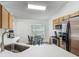 An open kitchen features white countertops, wooden cabinets, and stainless-steel appliances at 400 Landress Ln, Deland, FL 32724