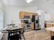 Cozy kitchen with wood cabinets, stainless steel appliances, and an adjacent dining area with a round table at 400 Landress Ln, Deland, FL 32724