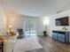 Bright living room with sliding glass doors that lead to a screened-in patio and pool at 400 Landress Ln, Deland, FL 32724