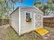 Durable outbuilding with a ramp and window box provides ample space for storage at 400 Landress Ln, Deland, FL 32724