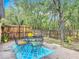 Outdoor patio with an ornate black metal table and chairs on a bright, colorful patterned rug at 400 Landress Ln, Deland, FL 32724