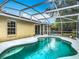 Relaxing screened-in pool area featuring backyard view and mature landscaping that provides privacy at 400 Landress Ln, Deland, FL 32724