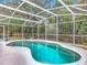 Inviting screened-in pool area with lush, mature trees, a tranquil setting and plenty of shade at 400 Landress Ln, Deland, FL 32724