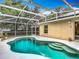 An inviting in-ground pool with steps for easy entry and surrounded by a screened enclosure at 400 Landress Ln, Deland, FL 32724