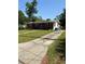 A modest brick ranch-style home with a long driveway at 404 Brentwood Ave, Deland, FL 32724