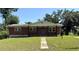 Charming brick home with a welcoming front porch and a well-manicured lawn at 404 Brentwood Ave, Deland, FL 32724