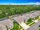 Picturesque aerial view of homes surrounded by lush landscaping, with mature trees in the background at 409 Nowell Loop, Deland, FL 32724