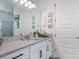 Bright bathroom vanity featuring a granite countertop, white cabinetry, and modern fixtures at 409 Nowell Loop, Deland, FL 32724