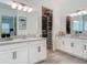 Bathroom features dual sinks, granite counters, white cabinets, tiled floors and an open closet at 409 Nowell Loop, Deland, FL 32724