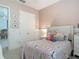 Adorable bedroom showcases a plush bed with princess bedding and decor and a view into the closet at 409 Nowell Loop, Deland, FL 32724