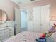 Charming pink bedroom features an open closet door, white dresser and princess-themed bedding and decor at 409 Nowell Loop, Deland, FL 32724