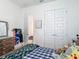 Bright bedroom with white trim, a kid-themed wall decoration, and double doors leading to the closet at 409 Nowell Loop, Deland, FL 32724