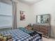 This bedroom features a unique wooden dresser, a cozy bed, and a Deadpool poster on the wall at 409 Nowell Loop, Deland, FL 32724