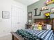 Colorful room featuring olive green walls, Ghostbusters decor, and a comfy bed with stuffed animals at 409 Nowell Loop, Deland, FL 32724