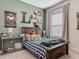 Charming bedroom with wood bed frame, Ghostbusters decor, and various collectibles on display at 409 Nowell Loop, Deland, FL 32724