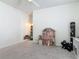 Open bonus room with a dollhouse, seating, and built-in shelving for toys and books at 409 Nowell Loop, Deland, FL 32724