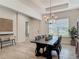 Bright dining room with a modern light fixture, offering an inviting space for meals and gatherings at 409 Nowell Loop, Deland, FL 32724