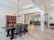 Elegant dining room featuring a stylish table, chandelier, and seamless transition to the living area at 409 Nowell Loop, Deland, FL 32724