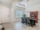 Bright dining room with modern light fixture and natural light from a large window at 409 Nowell Loop, Deland, FL 32724