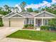 Charming single-story home with lush green lawn and manicured landscaping at 409 Nowell Loop, Deland, FL 32724