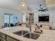 Bright kitchen with large island, stainless steel sink, and view of the living room and patio at 409 Nowell Loop, Deland, FL 32724
