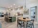 Bright kitchen boasts stainless steel appliances, granite countertops, and eat-in dining area at 409 Nowell Loop, Deland, FL 32724