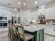 Bright kitchen featuring a spacious island with seating and modern pendant lighting at 409 Nowell Loop, Deland, FL 32724