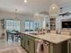 Open kitchen with large island, stainless steel appliances, and view of the outdoor dining area at 409 Nowell Loop, Deland, FL 32724