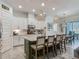 Bright kitchen featuring a spacious island with seating and modern pendant lighting at 409 Nowell Loop, Deland, FL 32724