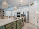 Bright kitchen with a spacious island, stainless steel appliances, and ample counter space at 409 Nowell Loop, Deland, FL 32724