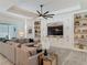 Spacious open living room features custom shelving and large sectional sofa at 409 Nowell Loop, Deland, FL 32724