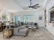 Open living room features a large sectional sofa and custom built-ins at 409 Nowell Loop, Deland, FL 32724