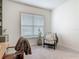 Cozy room with chair with natural light streaming through window at 409 Nowell Loop, Deland, FL 32724