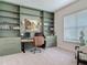 Home office with custom green built-ins, and ample natural light at 409 Nowell Loop, Deland, FL 32724