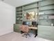 Home office with custom green built-ins, and ample natural light at 409 Nowell Loop, Deland, FL 32724