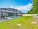Relaxing screened pool with lounge chairs and a lush backyard at 409 Nowell Loop, Deland, FL 32724