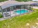 A refreshing screened pool with a paver deck and poolside seating at 409 Nowell Loop, Deland, FL 32724