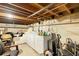 Unfinished basement featuring a washer and dryer, exposed beams, and ample storage space at 409 S Sparkman Ave, Orange City, FL 32763