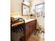 Bathroom featuring a wooden vanity, a framed mirror, and patterned floor mat at 409 S Sparkman Ave, Orange City, FL 32763