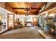 Living room with a brick fireplace, wood-paneled ceiling, and rustic chandelier at 409 S Sparkman Ave, Orange City, FL 32763