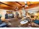 Spacious living room featuring a brick fireplace, wooden ceiling, and comfortable furnishings at 409 S Sparkman Ave, Orange City, FL 32763