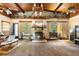Living room showcasing a brick fireplace, wooden ceiling, and natural light at 409 S Sparkman Ave, Orange City, FL 32763