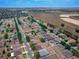 An expansive aerial view of a community near fields, highlighting well-spaced homes and the subject property with a red indicator at 4604 Barbados Loop, Clermont, FL 34711