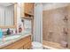 Bathroom featuring a shower and vanity with granite countertops at 4604 Barbados Loop, Clermont, FL 34711