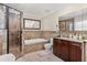 Well-appointed bathroom with a shower, tub, vanity, and tiled walls at 4604 Barbados Loop, Clermont, FL 34711